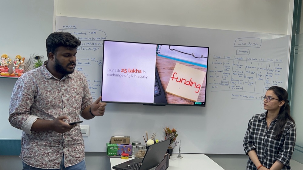 Jordensky colleagues presenting ideas beside a whiteboard